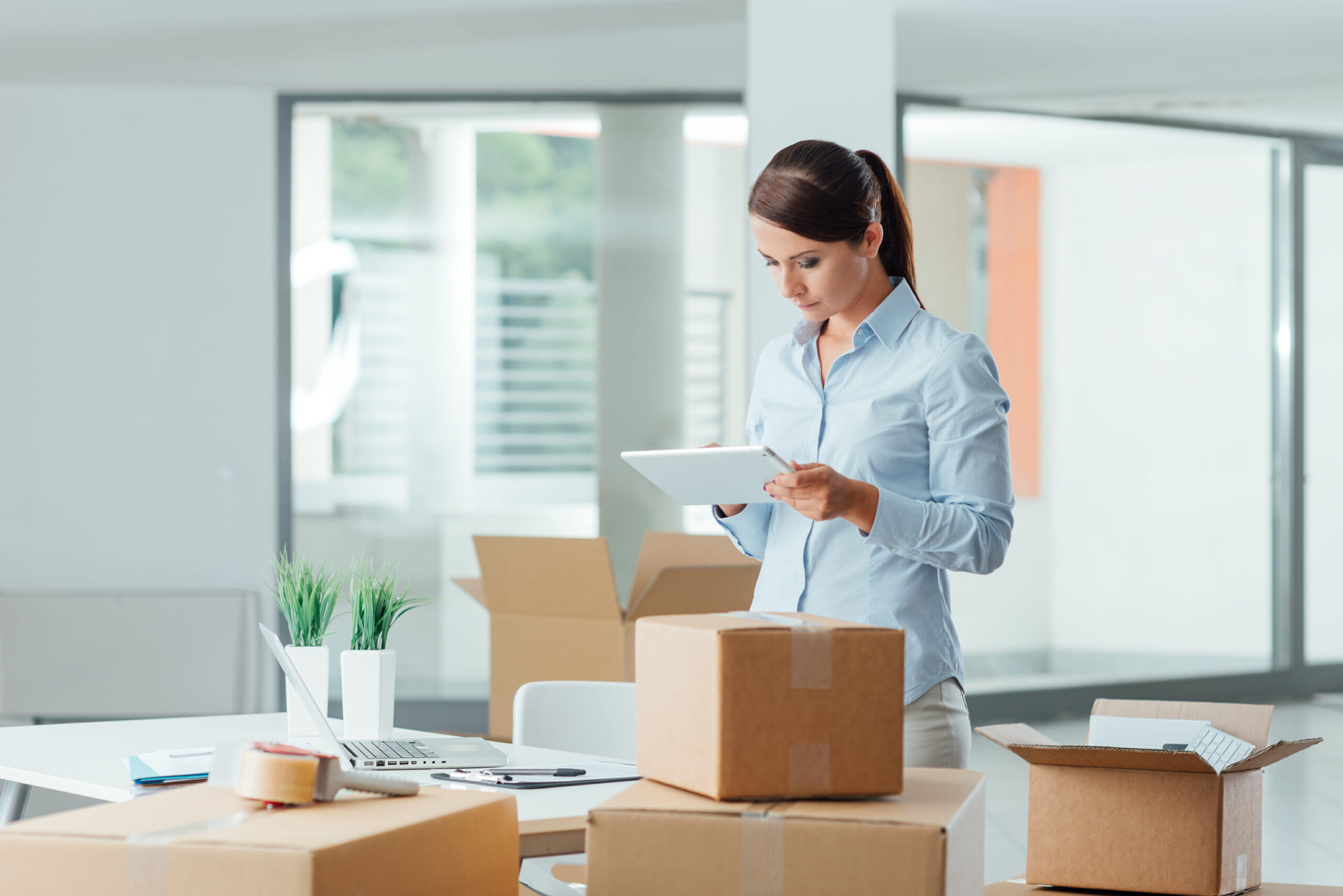 Women moving office uses tablet