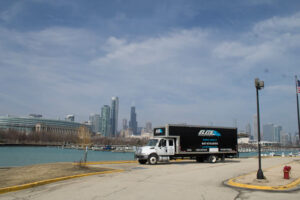 Elite moving truck, Chicago River, skyline, Sears tower