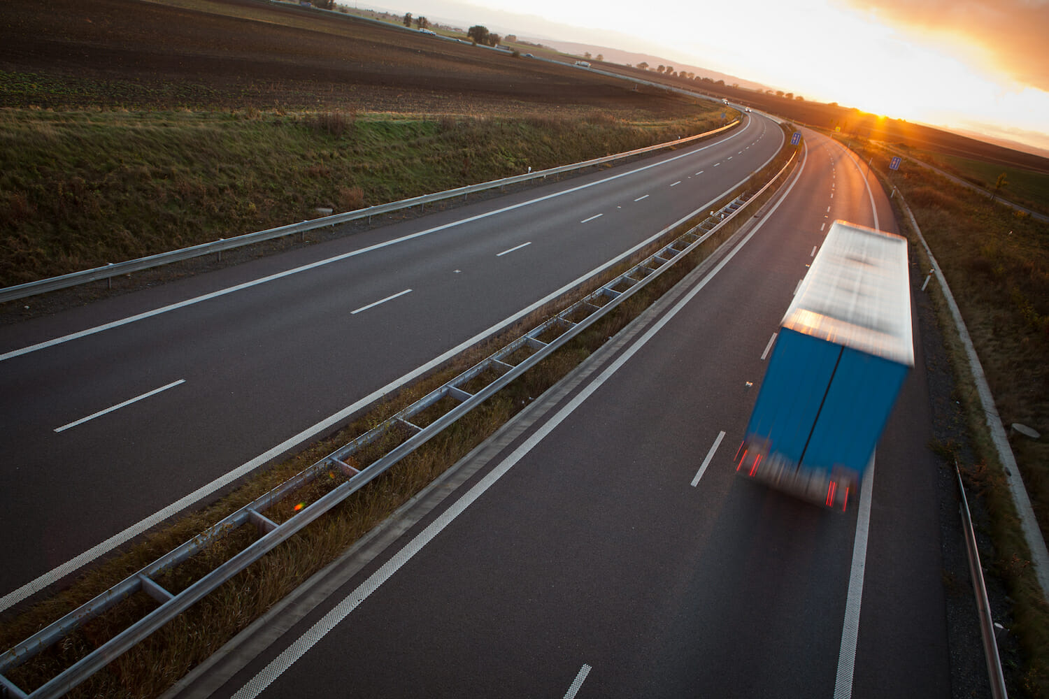 moving truck driving down highway
