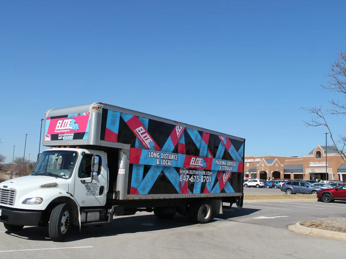 Side view of an Elite Moving and Storage truck in a parking lot during a Chicago area move